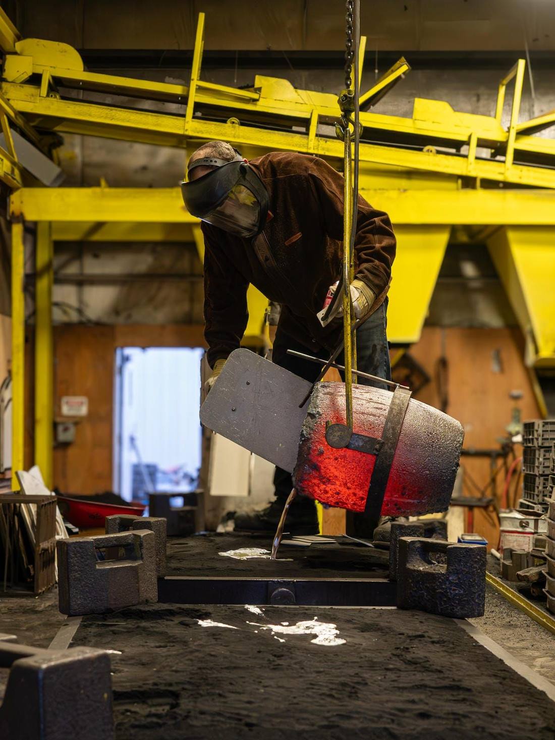 Pouring molten aluminum into a sand mould at Wellington Foundry